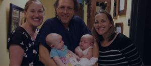 IVF Florida Clinic Dr Pabon posing with happy patients and babies